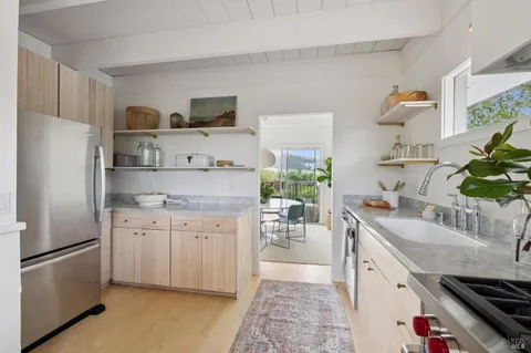 a kitchen with stainless steel appliances a sink a stove and a refrigerator