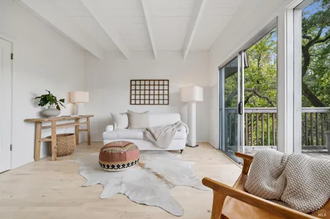 a bedroom with furniture and a large window
