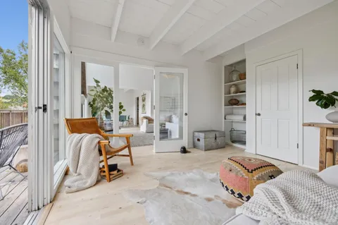 a bedroom with furniture and a large window