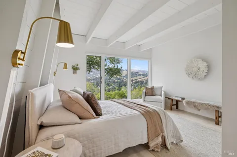 a bedroom with a large bed and a large window
