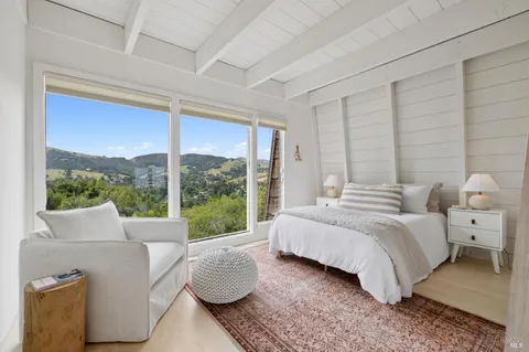 a bedroom with a bed and glass window