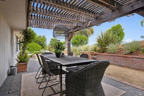 a view of a patio with table and chairs and potted plants