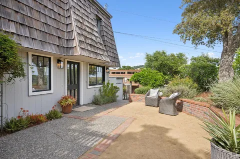 a view of a garden with an outdoor seating