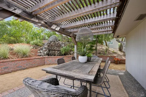 a view of a chairs and table in patio