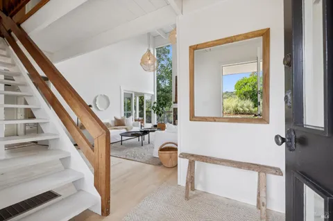 a view of staircase with white walls and a window