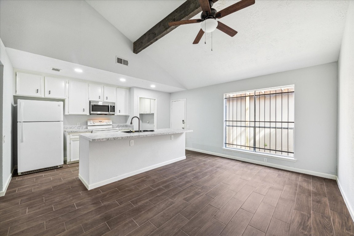 8628 Maplecrest Drive Houston, TX 77099 - Photo 2 of 10 a view of kitchen with stainless steel appliances granite countertop a stove top oven a refrigerator a sink and dishwasher with wooden floor