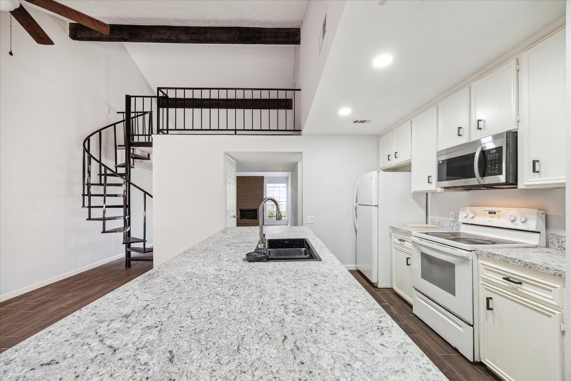 8628 Maplecrest Drive Houston, TX 77099 - Photo 3 of 10 a kitchen with stainless steel appliances kitchen island granite countertop a stove a sink and a refrigerator