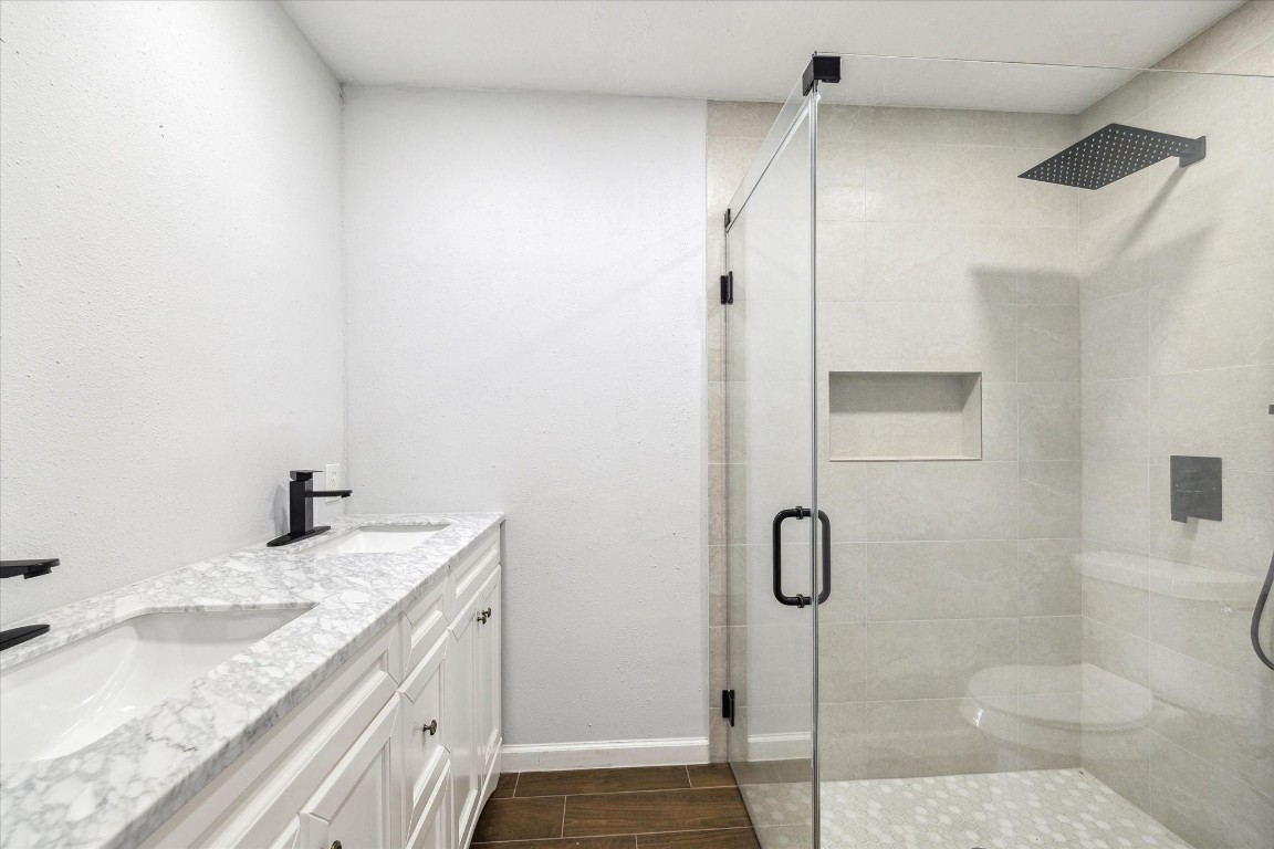 8628 Maplecrest Drive Houston, TX 77099 - Photo 10 of 10 a bathroom with a granite countertop sink a toilet and shower