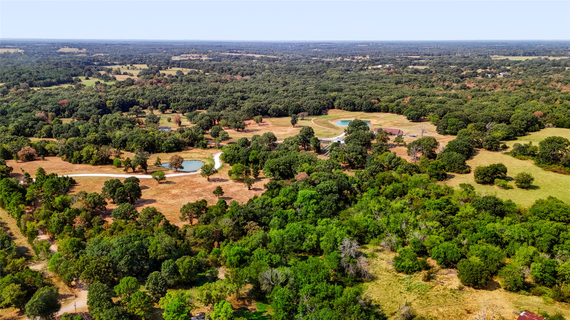3607 South Half Bank Road Atoka, OK 74525 - Photo 68 of 82 Expansive acreage featuring mature trees, open clearings, and two distinct ponds