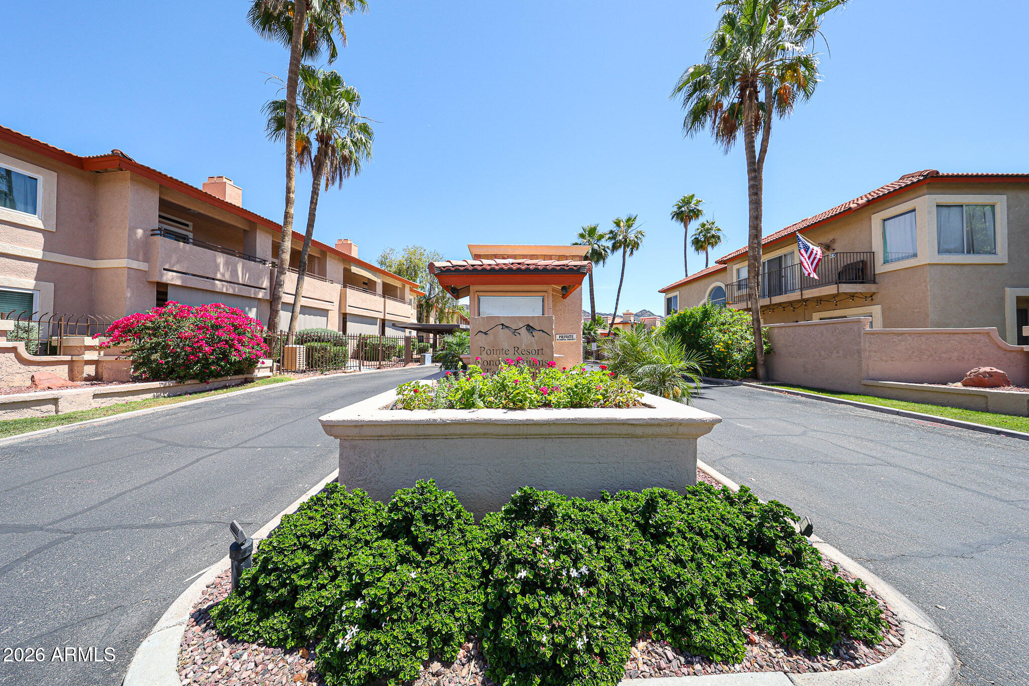 10410 North Cave Creek Road, Unit 1011 Phoenix, AZ 85020 - Photo 53 of 54 a front view of a house with a yard and potted plants