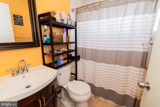 a bathroom with a sink toilet and window