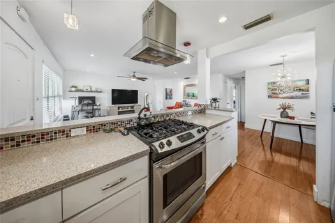 a kitchen with stainless steel appliances a stove a sink and a refrigerator