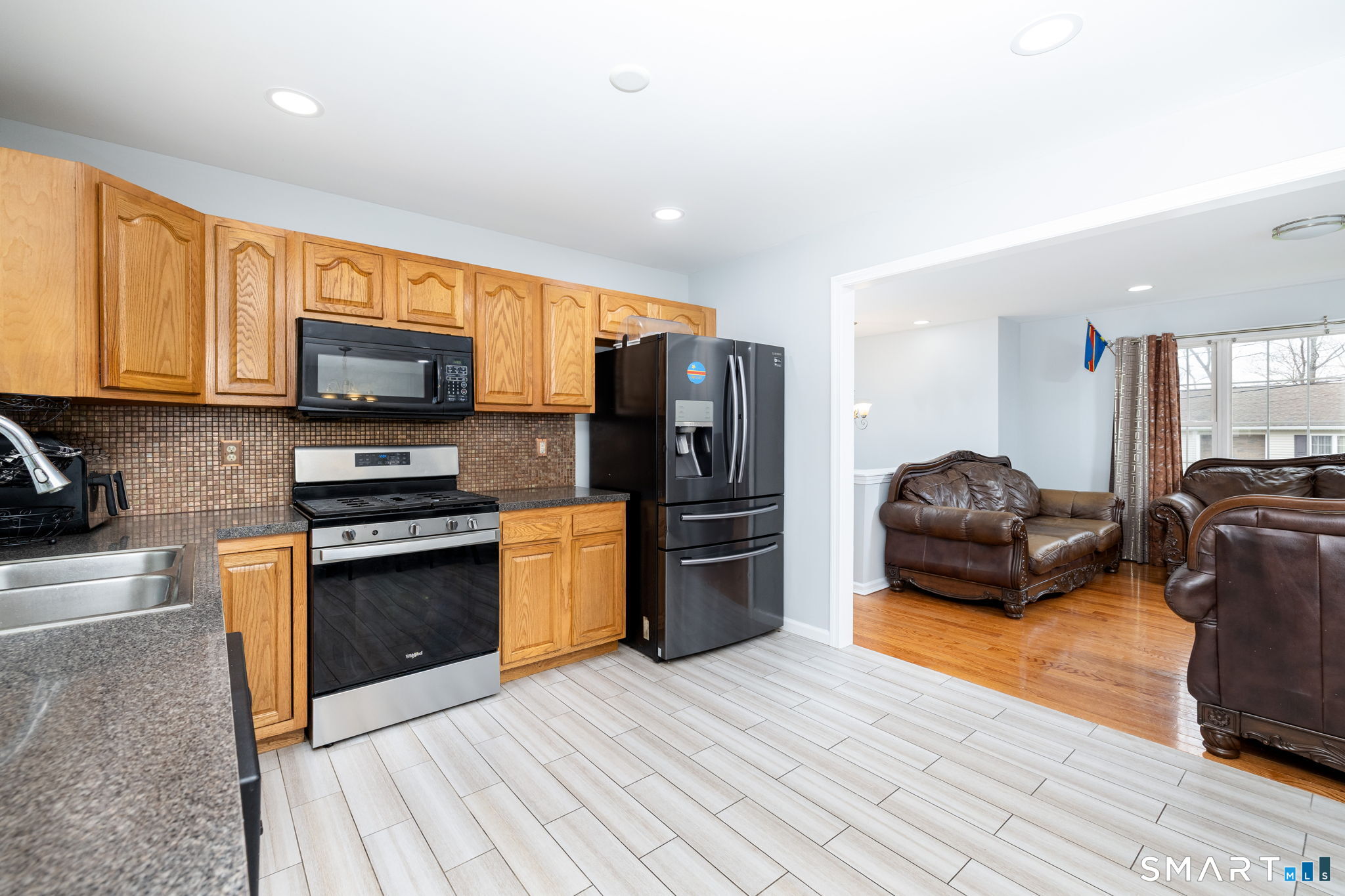 234 Traverse Street Waterbury, CT 06704 - Photo 13 of 38 a kitchen with stainless steel appliances granite countertop a refrigerator stove and oven