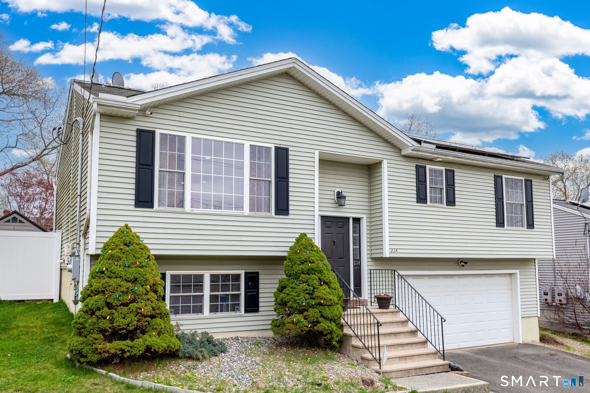 234 Traverse Street Waterbury, CT 06704 - Photo 6 of 38 a front view of a house with garden