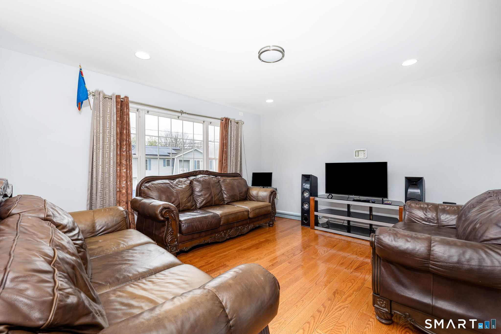 234 Traverse Street Waterbury, CT 06704 - Photo 8 of 38 a living room with furniture and a flat screen tv