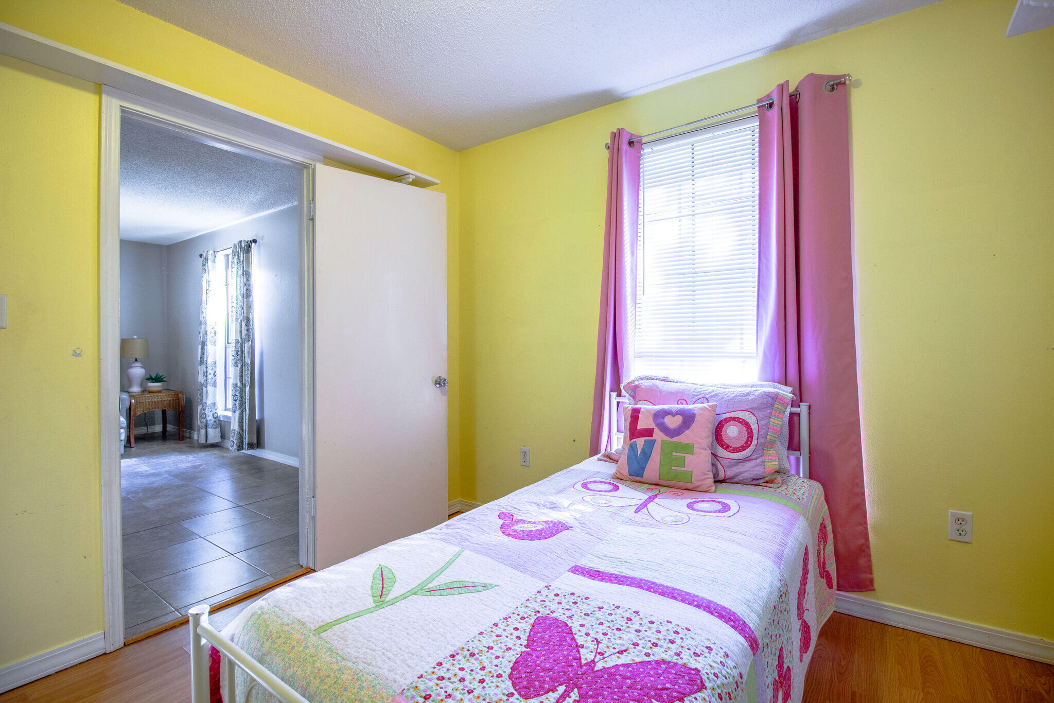 112 James Street Crestview, FL 32536 - Photo 13 of 16 a bedroom with a bed and wooden floor