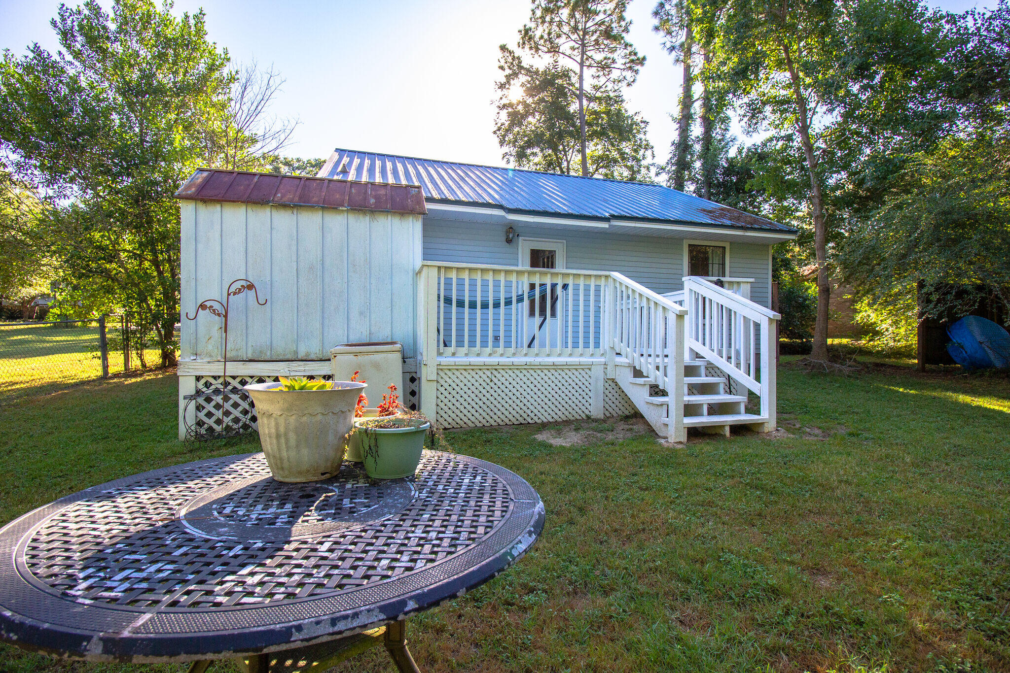 112 James Street Crestview, FL 32536 - Photo 14 of 16 a view of a chair and table in backyard of the house