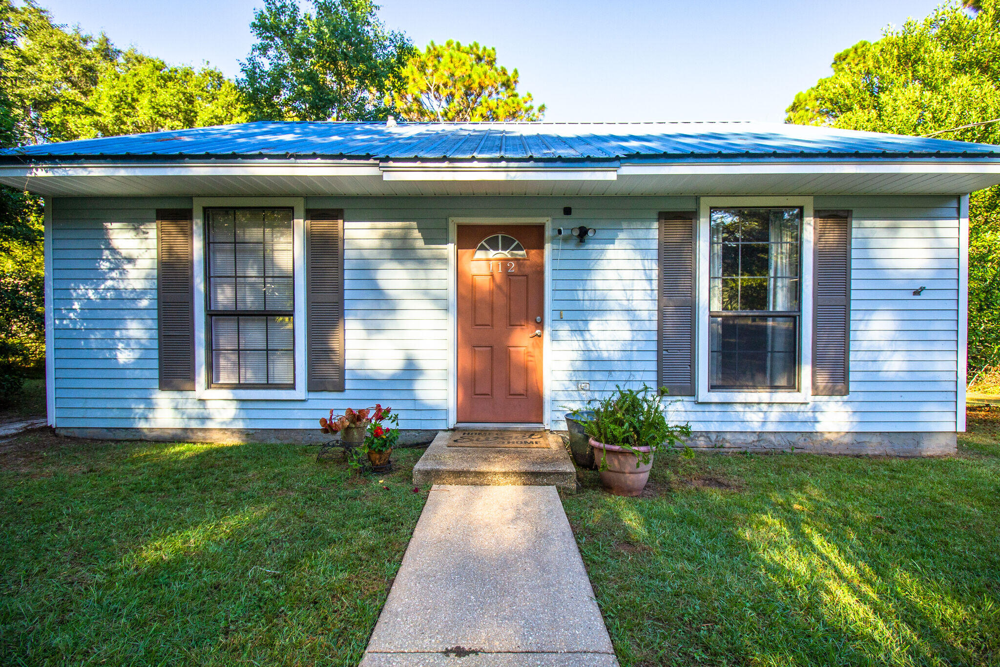 112 James Street Crestview, FL 32536 - Photo 2 of 16 a front view of a house with garden