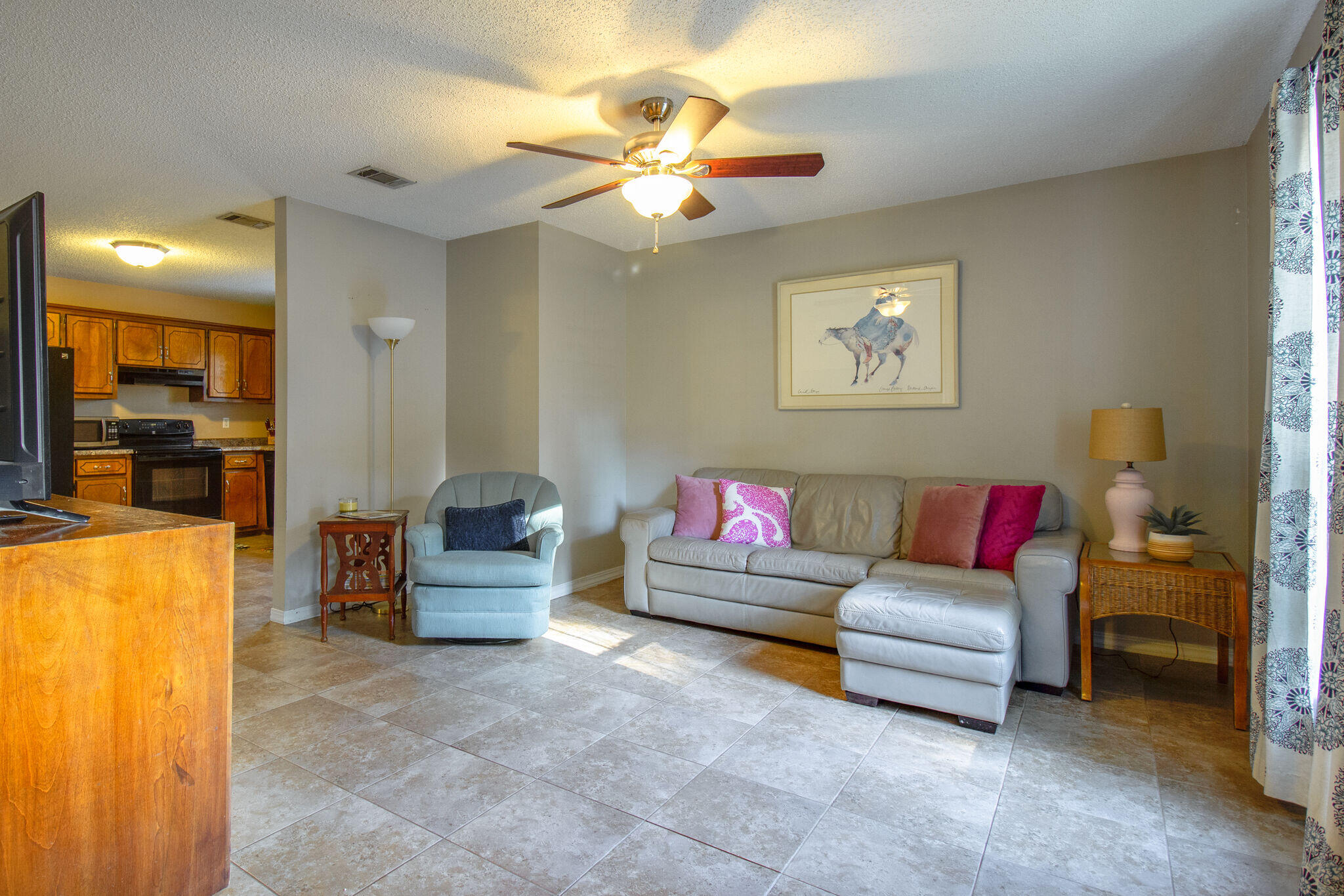 112 James Street Crestview, FL 32536 - Photo 3 of 16 a living room with furniture and a chandelier
