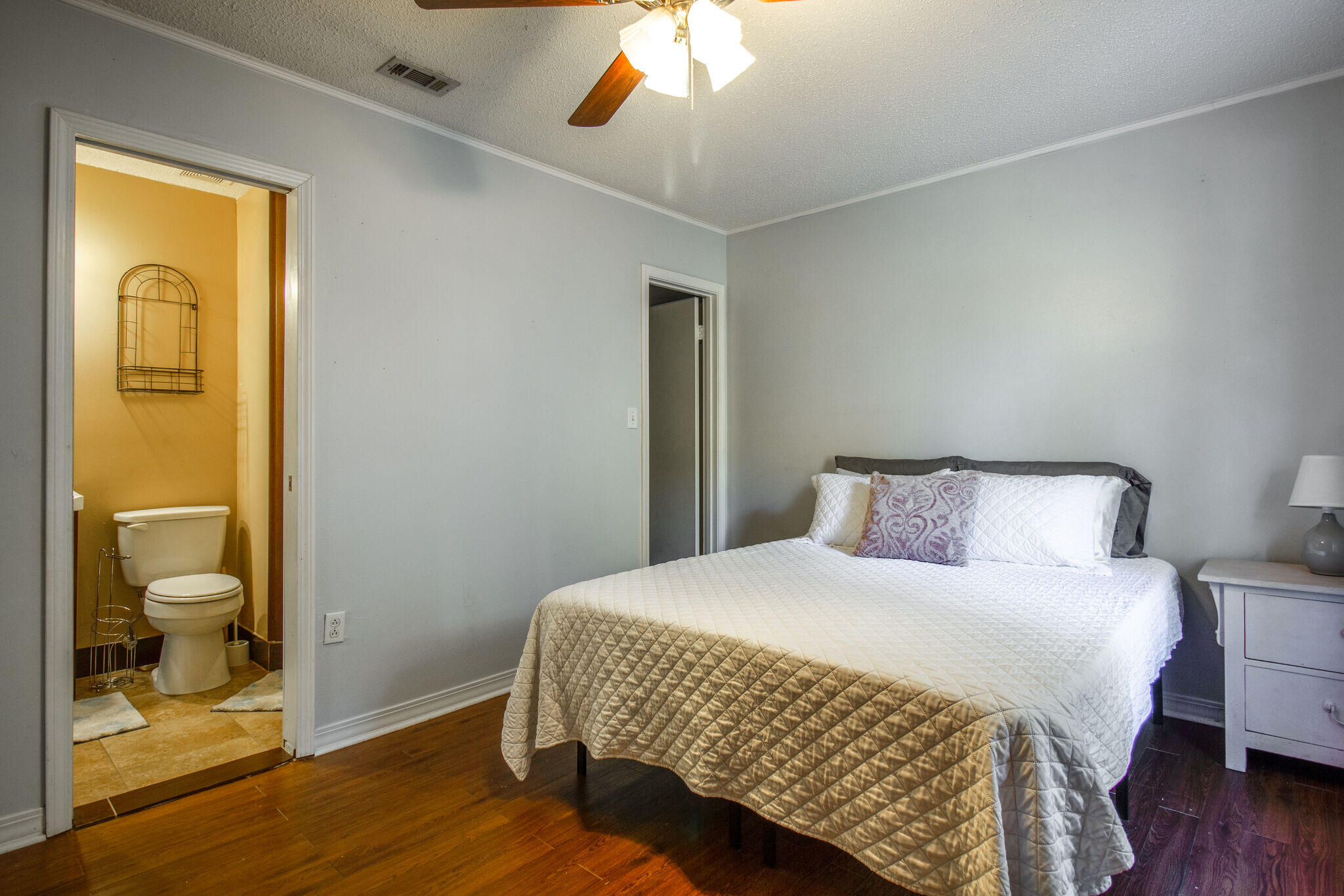 112 James Street Crestview, FL 32536 - Photo 8 of 16 a bedroom with a bed and wooden floor