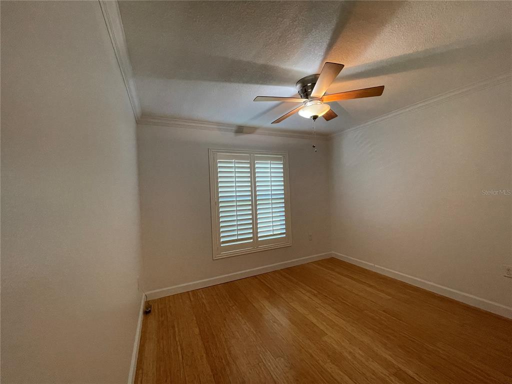 11956 Neal Road Lithia, FL 33547 - Photo 12 of 16 an empty room with a window and a fan