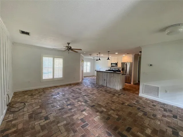 a view of a kitchen with a sink and cabinets