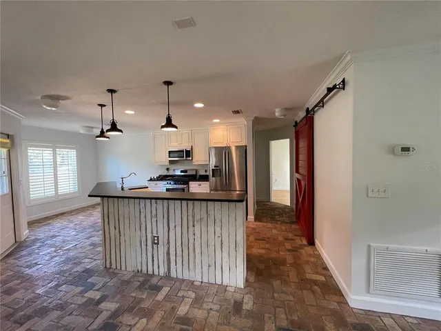 a view of kitchen and kitchen with furniture