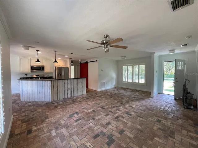 a view of a kitchen with a sink and a window