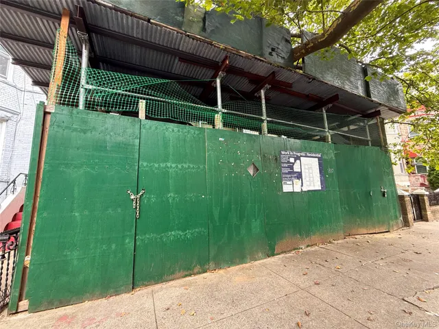 a backyard of a house with plants and wooden fence