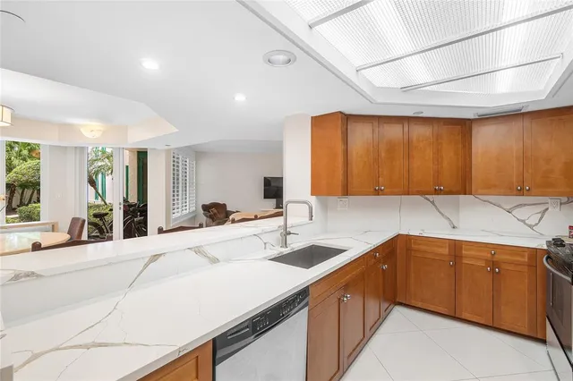 a kitchen with a sink a stove cabinets and a wooden floor