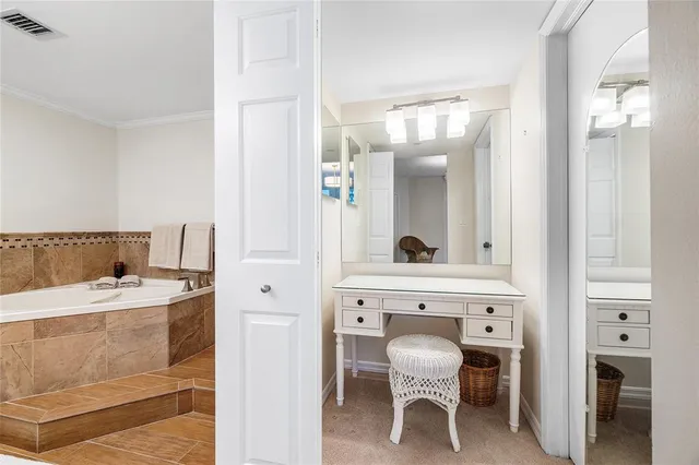 a bathroom with a tub sink and mirror