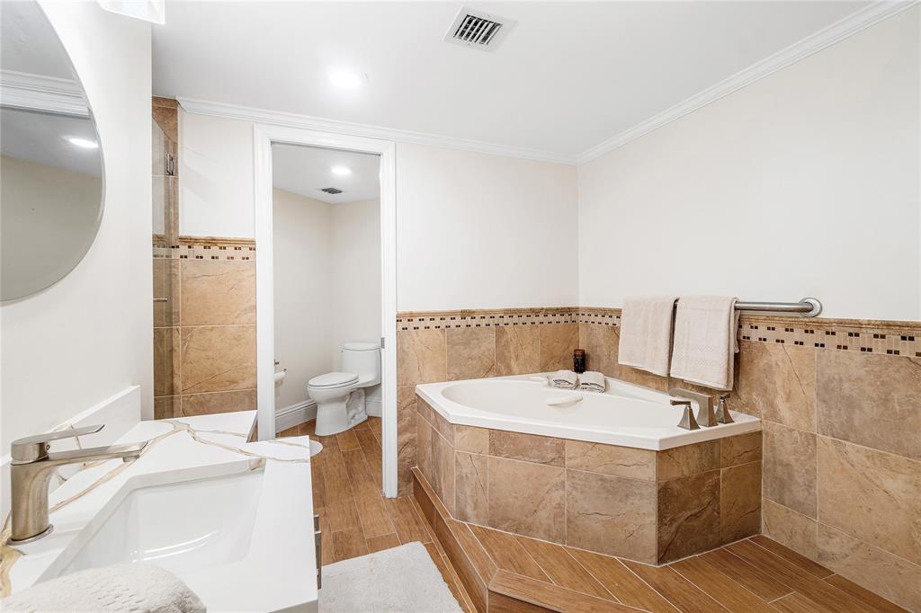 100 Southeast 5th Avenue, Unit 110 Boca Raton, FL 33432 - Photo 26 of 52 a bathroom with a tub sink and mirror
