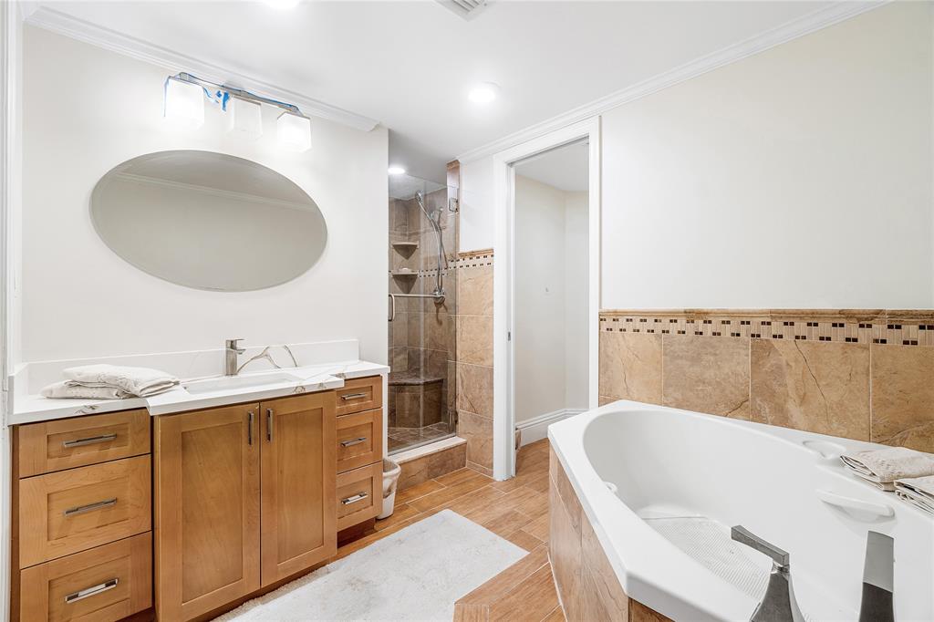 100 Southeast 5th Avenue, Unit 110 Boca Raton, FL 33432 - Photo 27 of 52 a bathroom with a granite countertop sink mirror vanity and bathtub