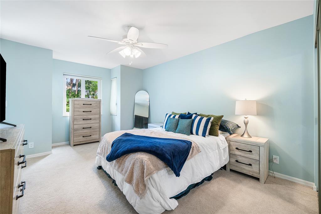 100 Southeast 5th Avenue, Unit 110 Boca Raton, FL 33432 - Photo 31 of 52 a bedroom with a bed and a chandelier