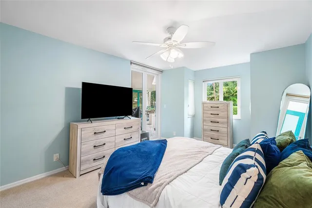 a bedroom with a bed a large window and couch