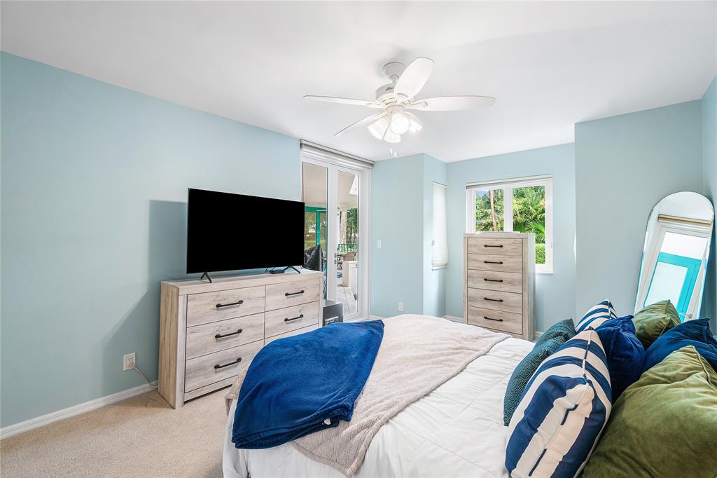 100 Southeast 5th Avenue, Unit 110 Boca Raton, FL 33432 - Photo 32 of 52 a bedroom with a bed and a flat screen tv