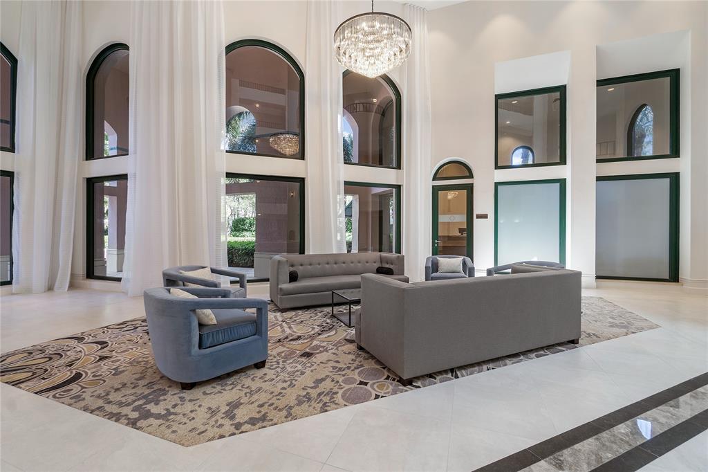 100 Southeast 5th Avenue, Unit 110 Boca Raton, FL 33432 - Photo 4 of 52 a living room with couches chairs and kitchen view