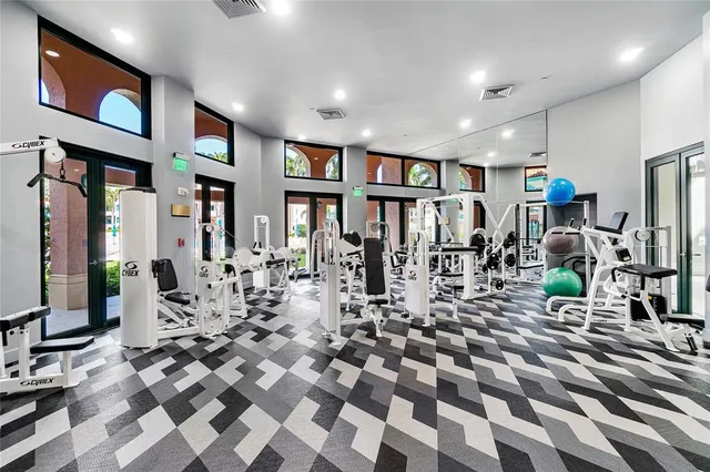 a living room with furniture a chandelier and a flat screen tv