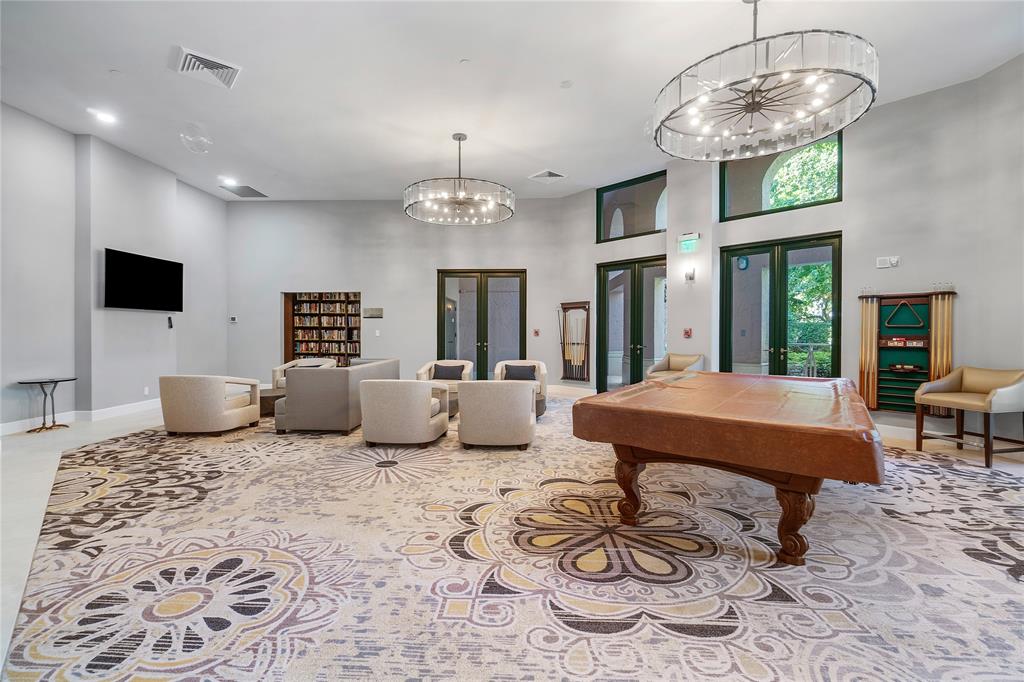 100 Southeast 5th Avenue, Unit 110 Boca Raton, FL 33432 - Photo 47 of 52 a living room with furniture a chandelier and a flat screen tv