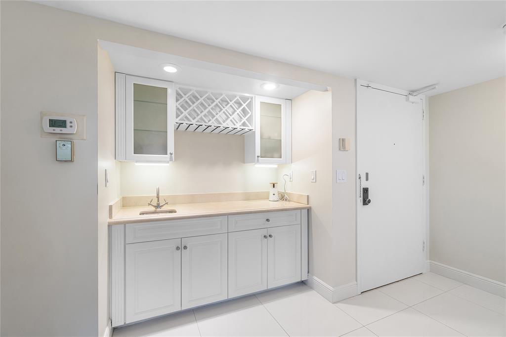100 Southeast 5th Avenue, Unit 110 Boca Raton, FL 33432 - Photo 10 of 52 a bathroom with a double vanity sink and mirror
