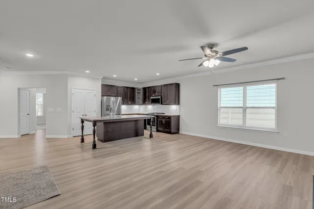 a view of kitchen with a sink cabinets and wooden floor