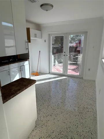 a kitchen with granite countertop a sink and a stove