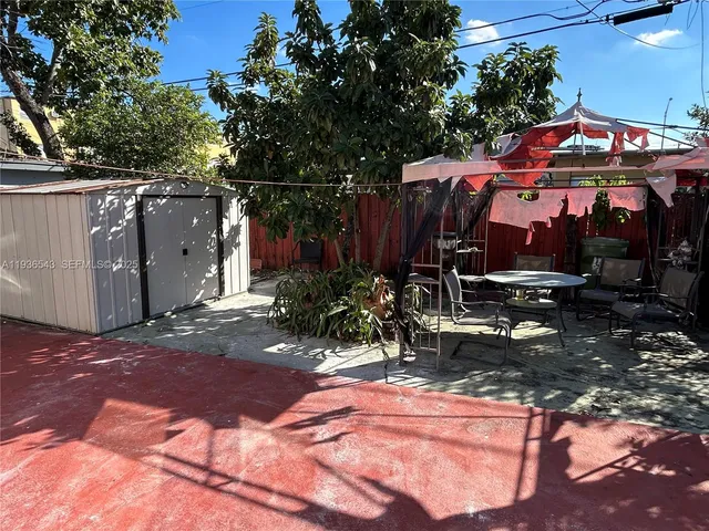 a view of a chairs and tables in a backyard