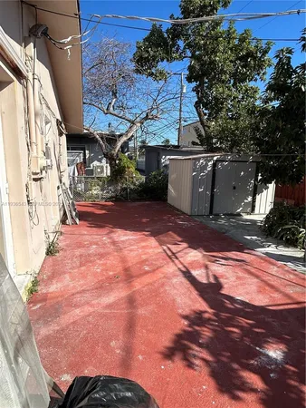 a view of a house with backyard porch and sitting area