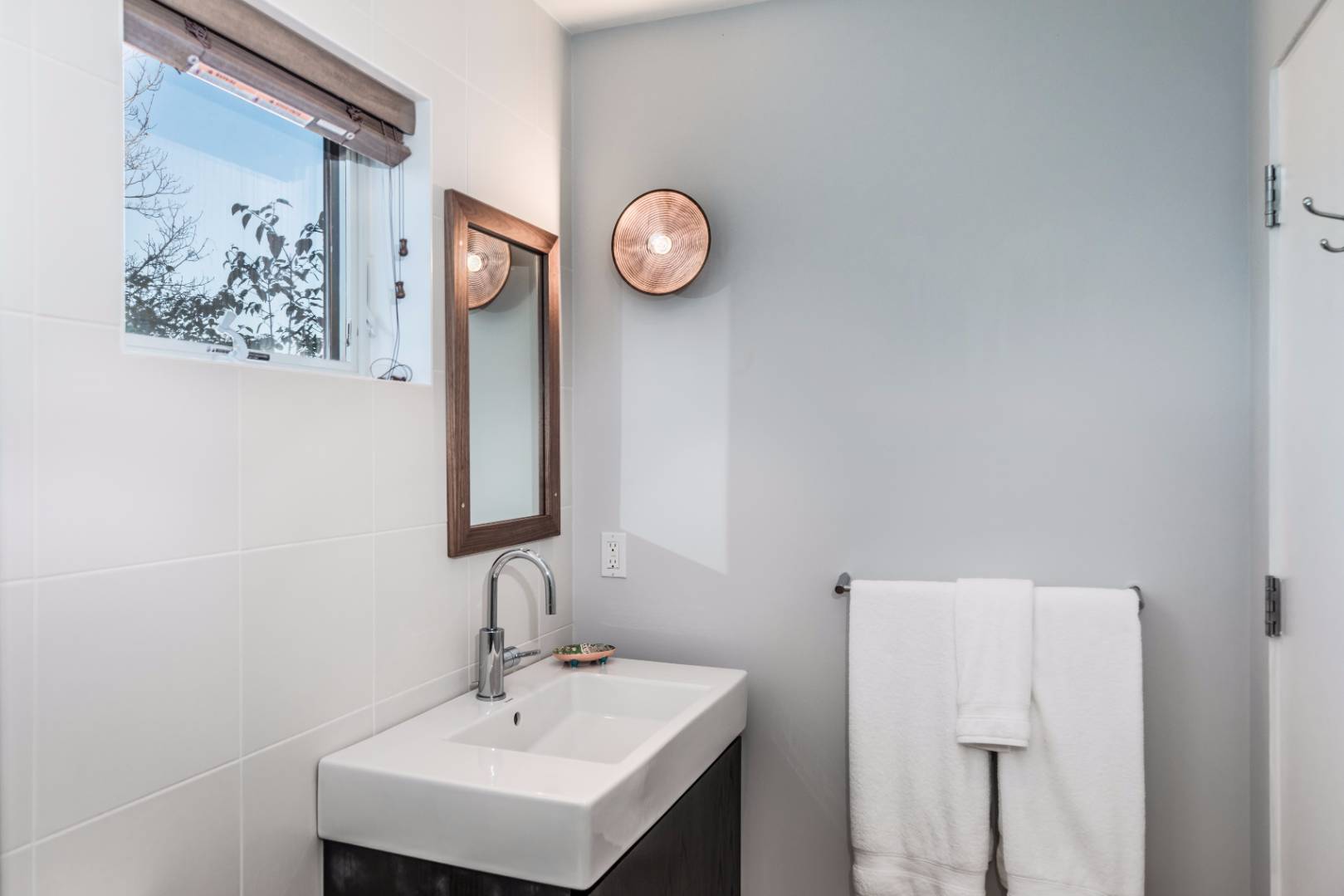 83 North Surfside Avenue Montauk, NY 11954 - Photo 20 of 26 a bathroom with a sink and a mirror