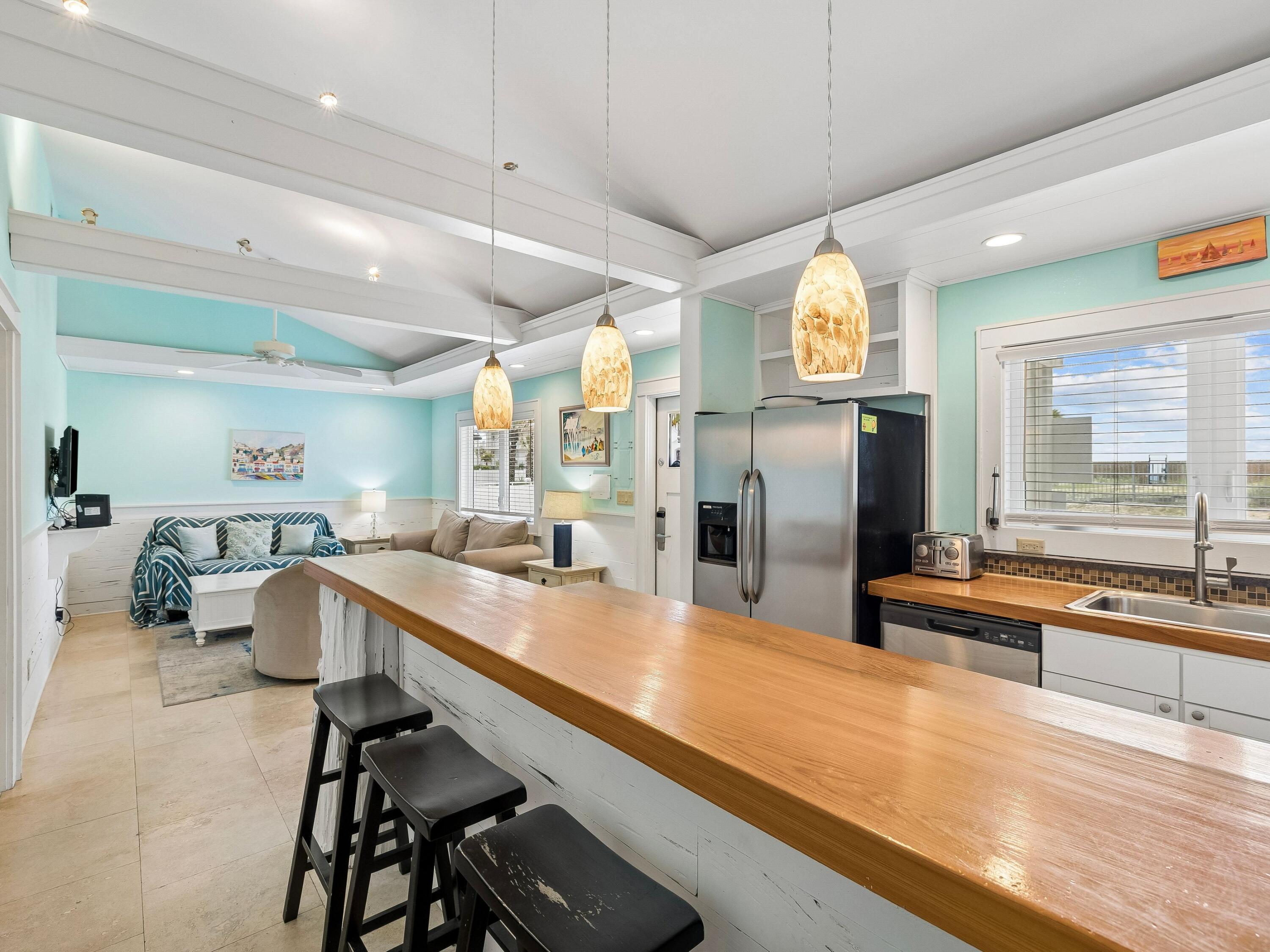 36 Green Street Inlet Beach, FL 32461 - Photo 8 of 27 a kitchen with stainless steel appliances granite countertop a sink and a refrigerator