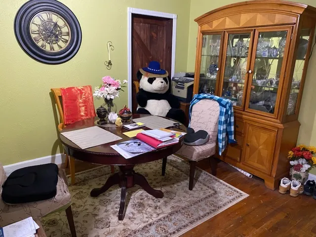 a view of a dining room with furniture and a window