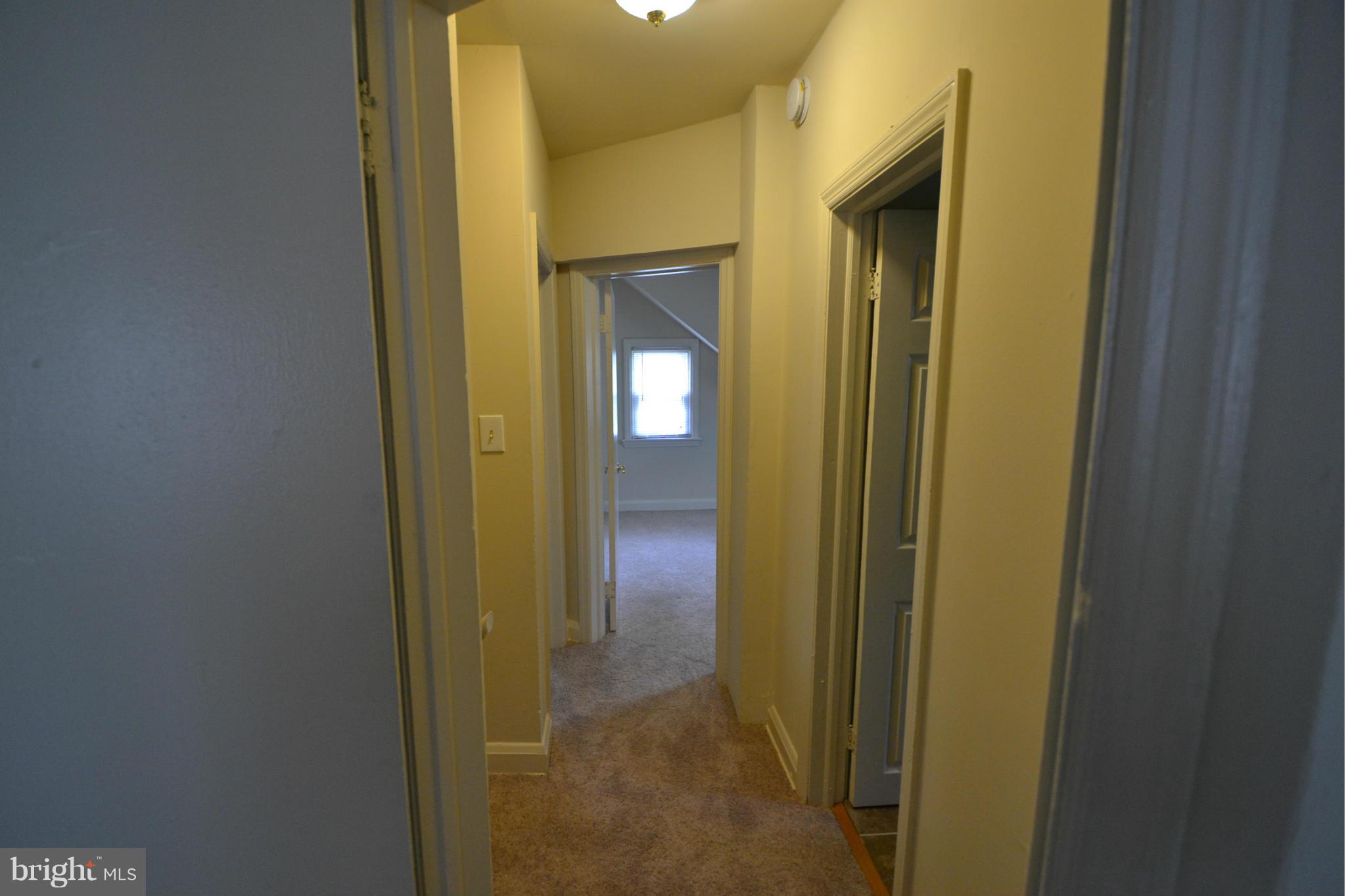 2504 Steele Road Baltimore, MD 21209 - Photo 17 of 21 a view of a bathroom with a glass door and a mirror