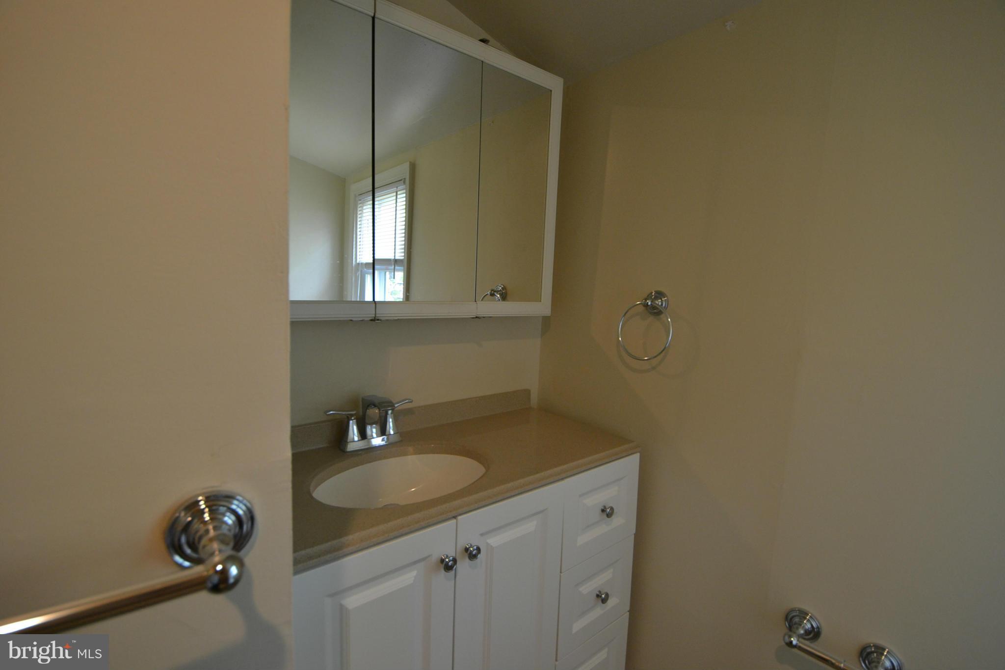 2504 Steele Road Baltimore, MD 21209 - Photo 19 of 21 a bathroom with a granite countertop sink and a mirror