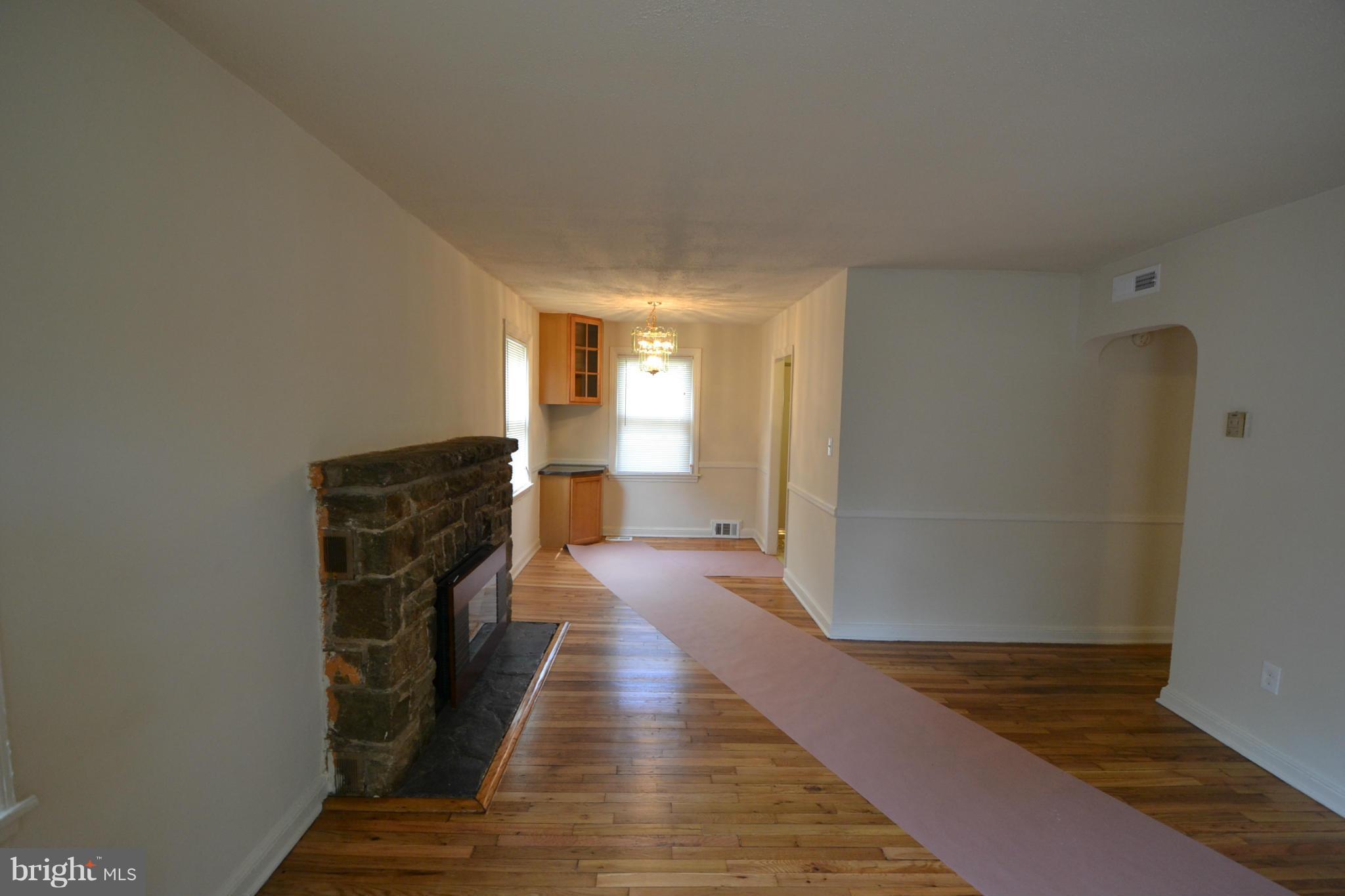 2504 Steele Road Baltimore, MD 21209 - Photo 3 of 21 a view of a hallway with wooden floor and staircase